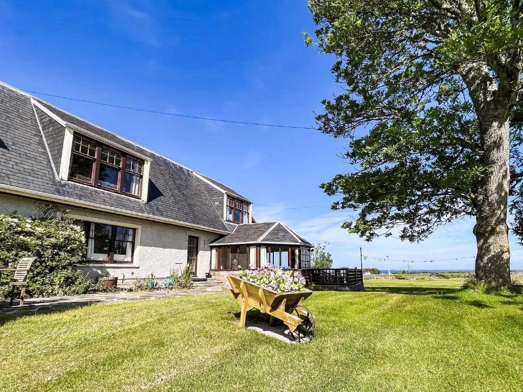 a wooden bench in the yard of a house at Fourpenny Studio - Uk34745 in Embo