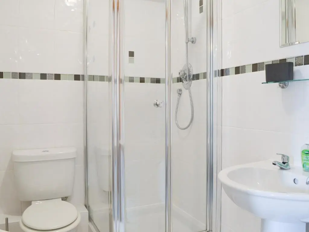 a bathroom with a shower and a toilet and a sink at Aurora in Lossiemouth