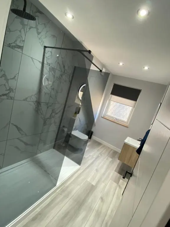 a room with a glass staircase with a window at Town centre 3 bed luxury apartment in Wick