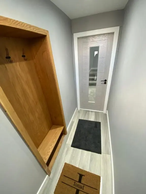 a room with a door and a rug on the floor at Town centre 3 bed luxury apartment in Wick