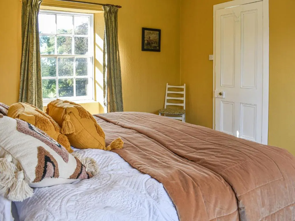 a bedroom with a large bed with a window at Hayfield - Uk35890 in Turriff