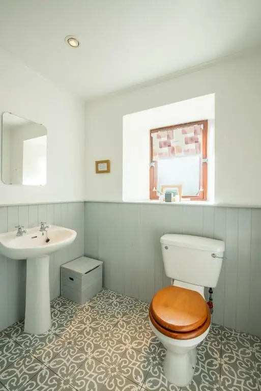 a bathroom with a toilet and a sink at Beautiful Character House in Muir of Ord in Muir of Ord