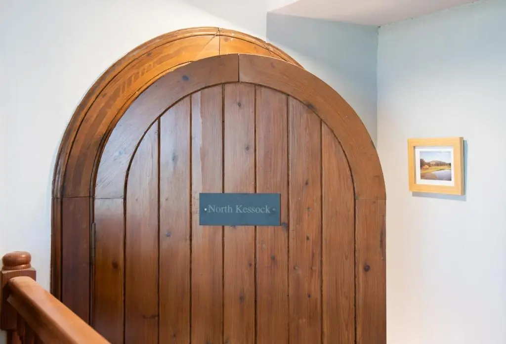 a large wooden door with a sign on it at Beautiful Character House in Muir of Ord in Muir of Ord