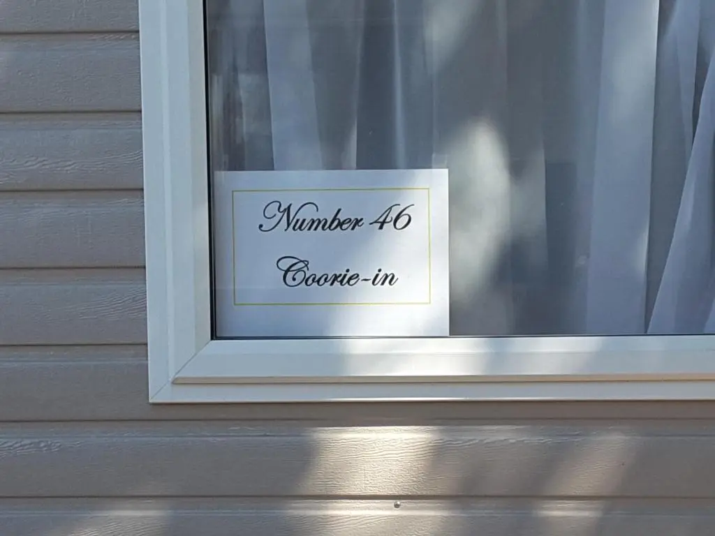 a sign in the window of a house at No 46 Coorie-in in Boat of Garten