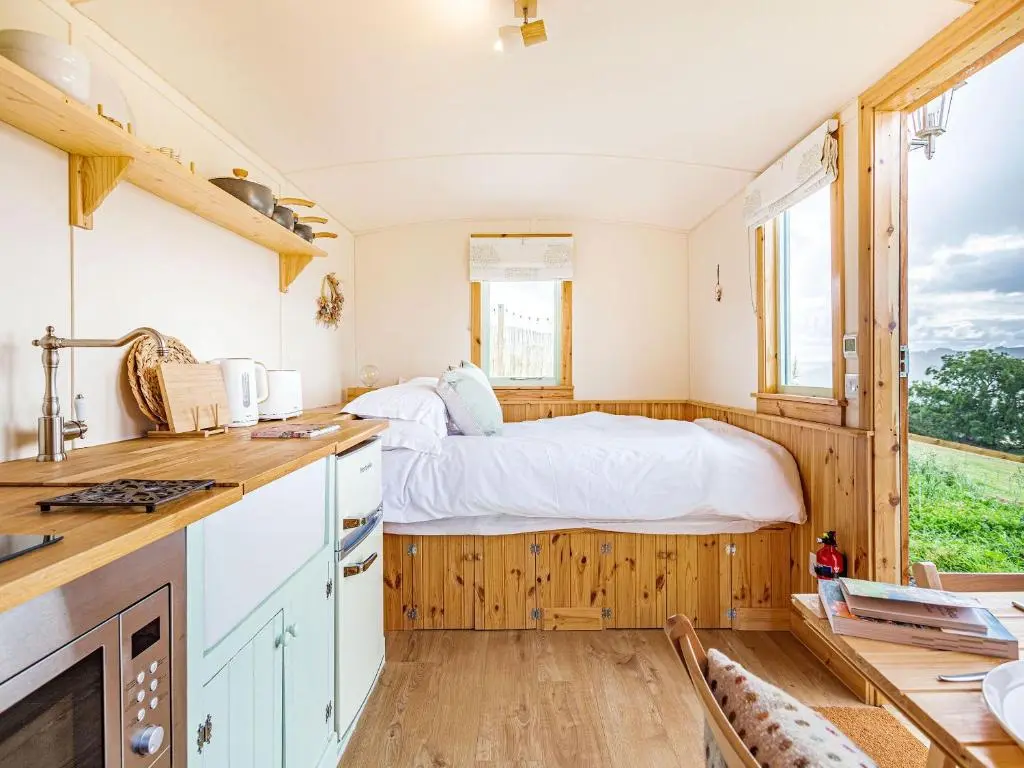 a bedroom with a bed in the middle of it at Woodside Hut 2 - Uk36106 in Auchterneed