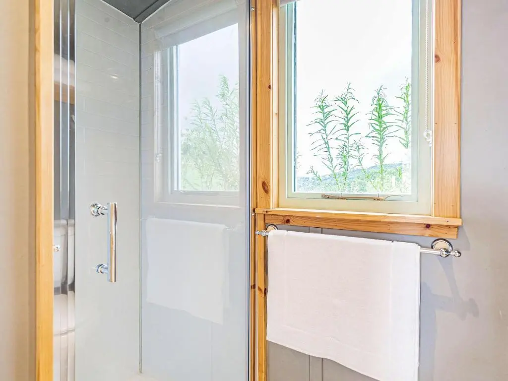 a bathroom with a window and a white towel at Woodside Hut 1 - Uk36105 in Auchterneed
