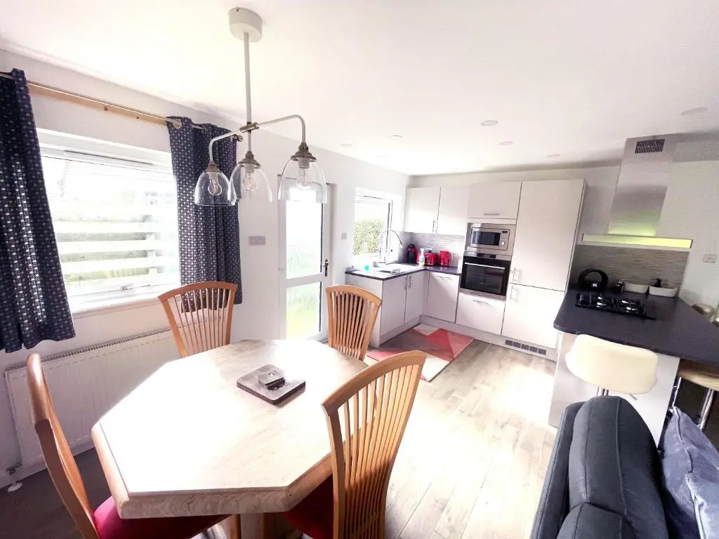 a kitchen and dining room with a table and chairs at Matara House Holiday Home in Inverness