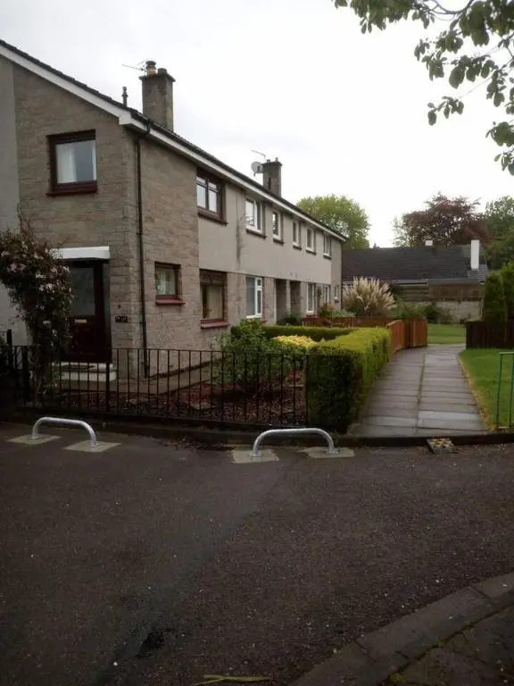 a brick house with a fence and a driveway at 3-Bed House Sleeps 5 5 min walk from City Centre in Inverness