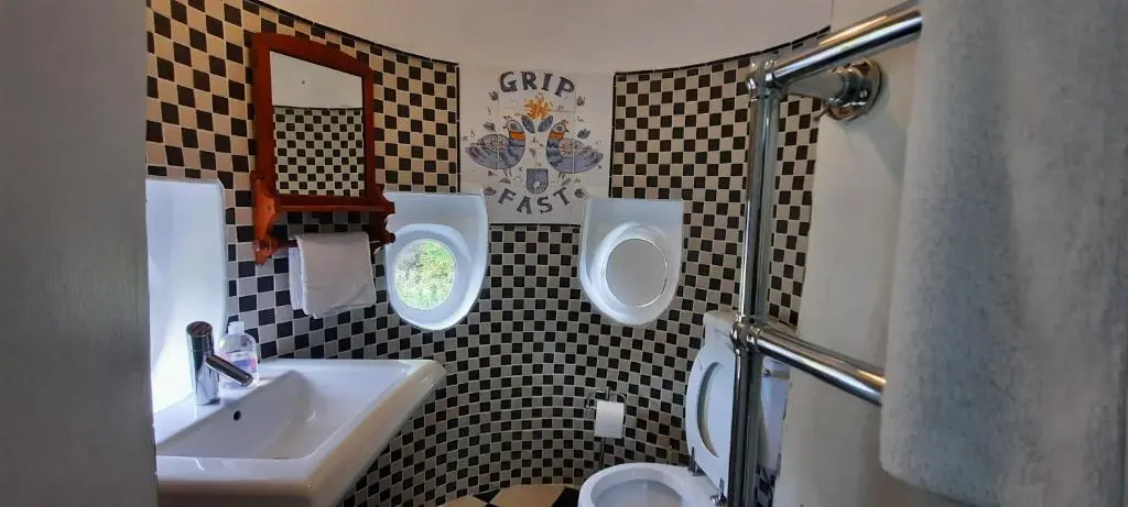 a bathroom with a sink and a toilet and a mirror at Lickleyhead Castle in Insch