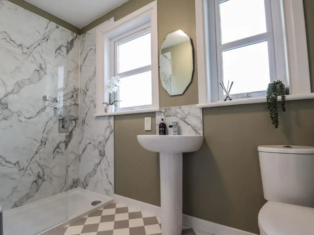 a bathroom with a sink and a toilet and a mirror at 62 Society Street in Nairn