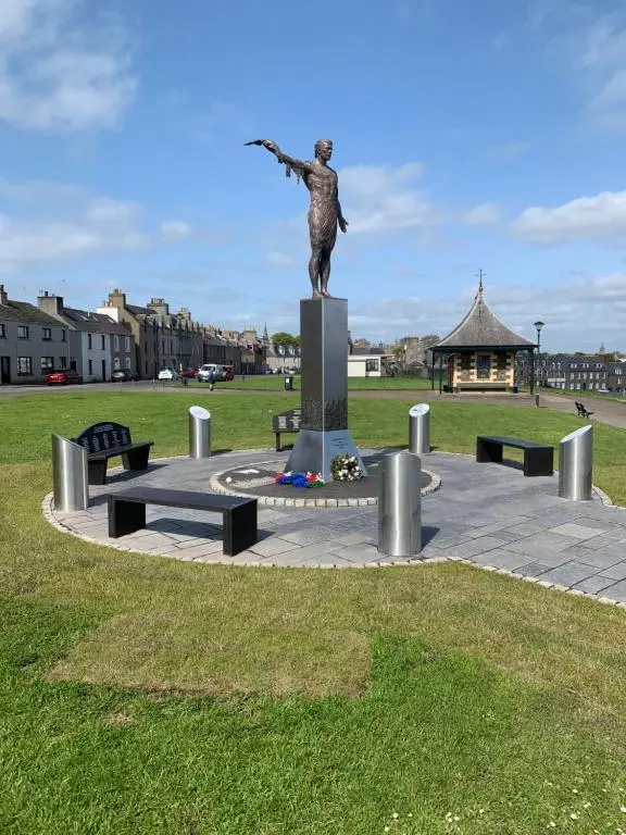 a statue of a woman with her arm out at Harbour View in Wick