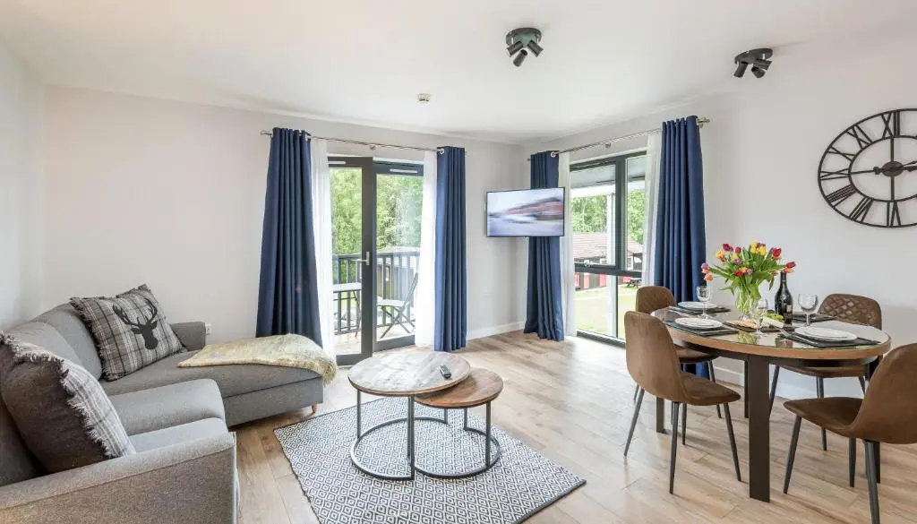 a living room with a couch and a table at High Range Holiday Apartments in Aviemore