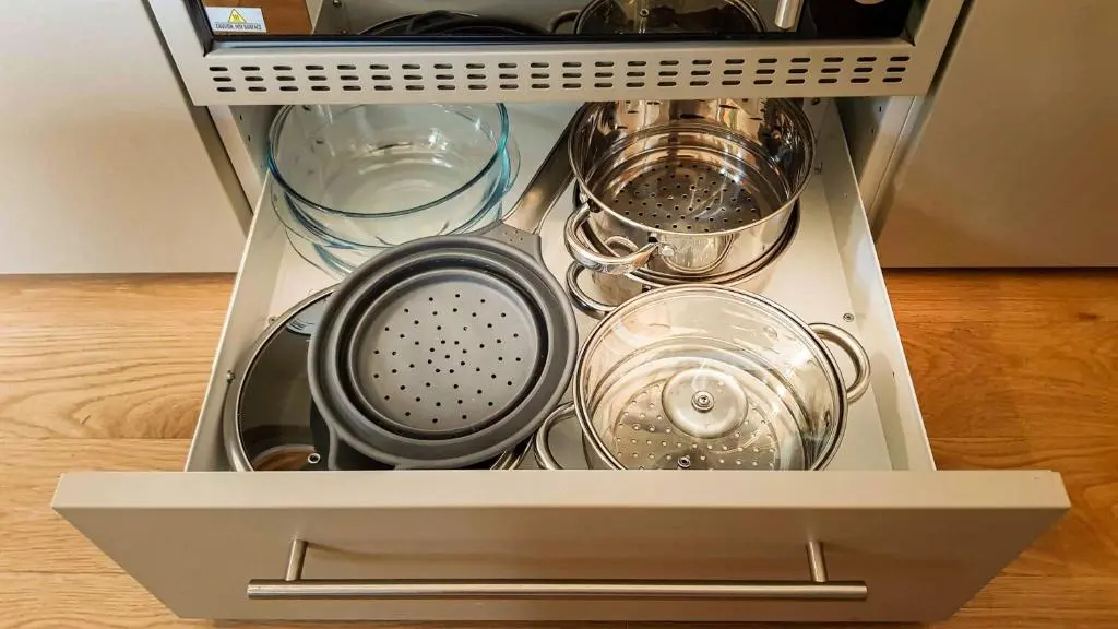 a drawer filled with dishes and other kitchen utensils at Marcassie Farm Lodges - Birch Studio in Forres