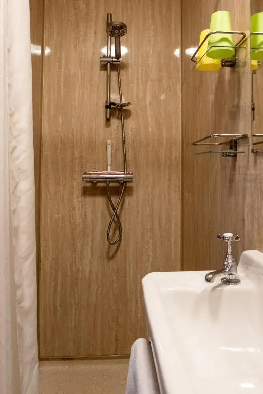 a bathroom with a sink and a mirror at Marcassie Farm Lodges - Hazel Studio in Forres