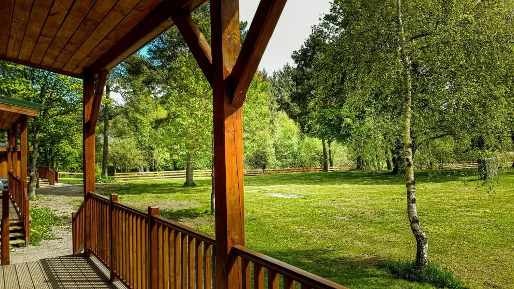 a porch of a cabin with a view of a park at Marcassie Farm Lodges - Hazel Studio in Forres