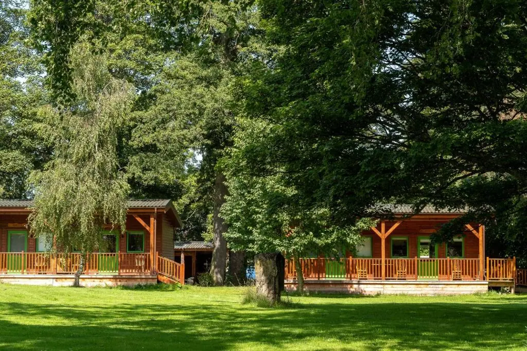 a house with a large deck in the yard at Marcassie Farm Lodges - Oak Studio - Accessible in Forres