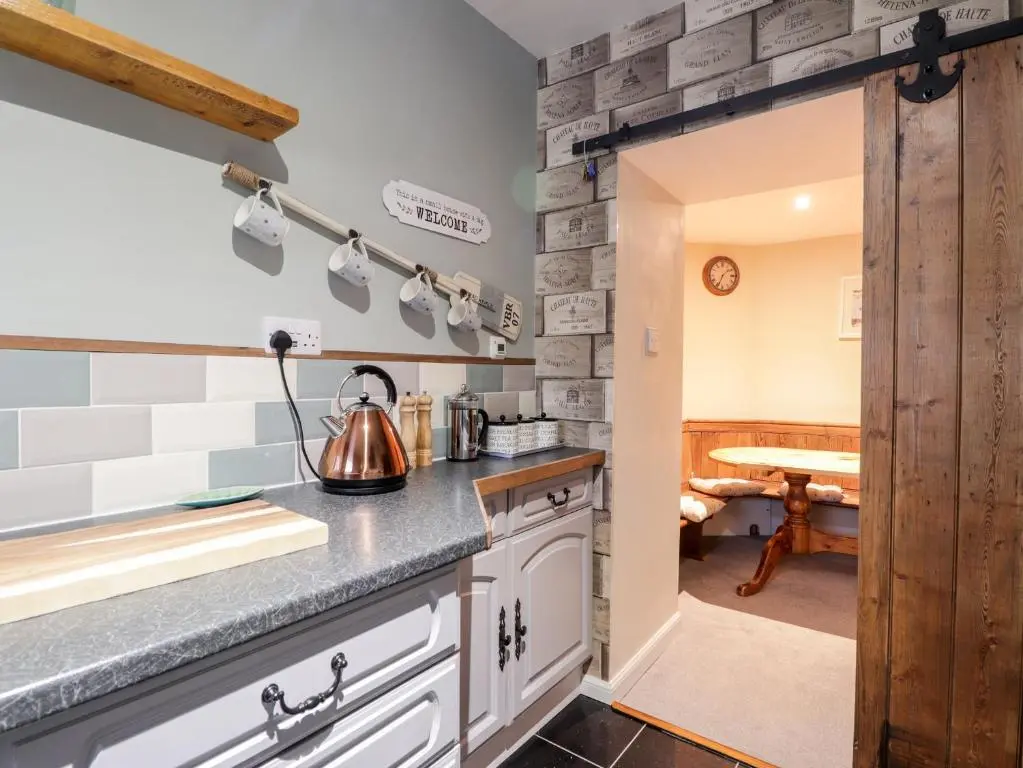 a kitchen with a sink and a counter top at Griffin Cottage in Nairn