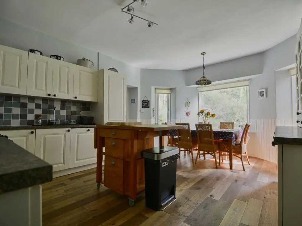 a kitchen and dining room with a table and chairs at Wester Curr Cottage - Luxury 5-Star Cottage with Private Pool & Hot Tub in Grantown on Spey