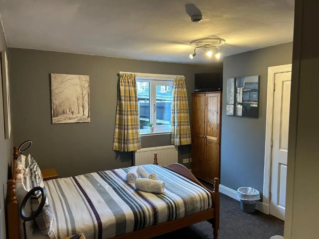a bedroom with a bed and a window at Winmar in Inverness
