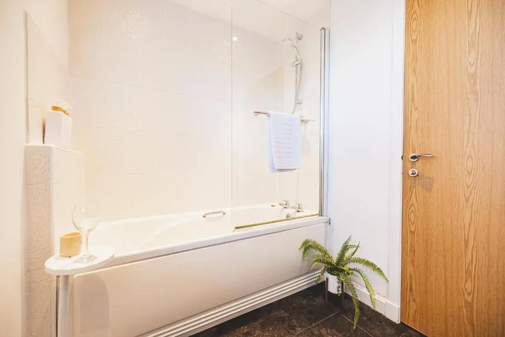 a white bathroom with a sink and a shower at Bright House with Garden & Patio in Market Town in Inverurie
