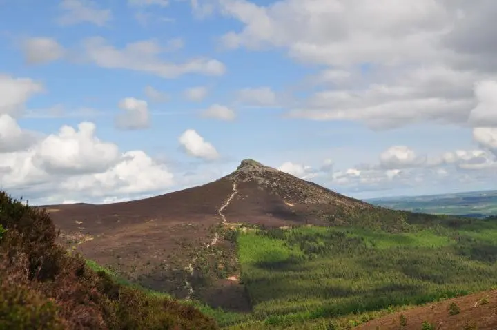 a mountain with a green hill in the distance at Bright House with Garden & Patio in Market Town in Inverurie