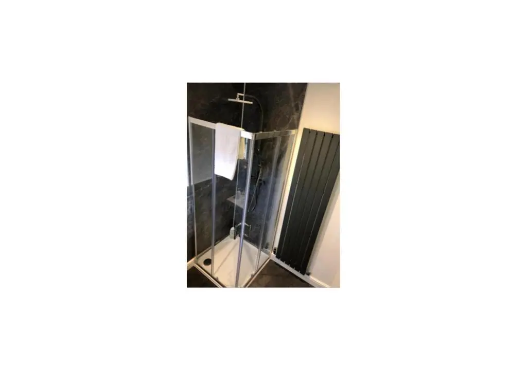 a mirror in the corner of a room at Grey Apartment in Inverness