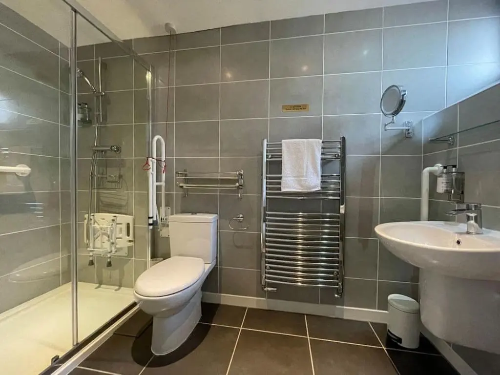 a bathroom with a toilet and a sink at Balloan Steading East in Dornoch
