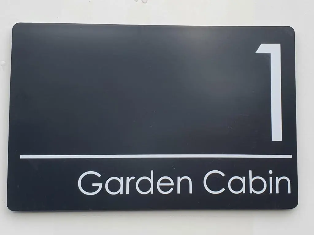 a black sign that says garden calith at Kingussie Garden Cabins in Kingussie