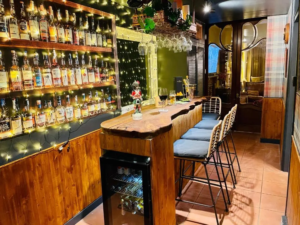 a bar with a lot of bottles of alcohol at Ladies Lodge Inverness in Inverness
