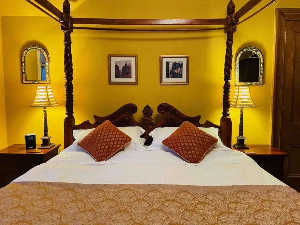 a bedroom with a large bed with two lamps at Ladies Lodge Inverness in Inverness