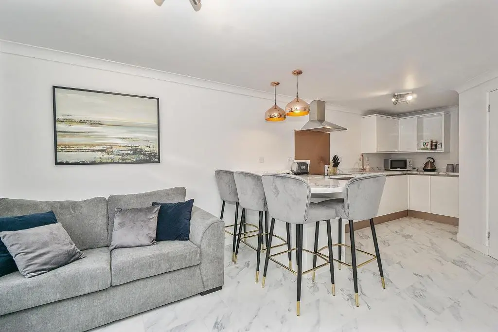 a living room with a couch and a table at Modern seaside apartment ,Lossiemouth, Moray in Lossiemouth