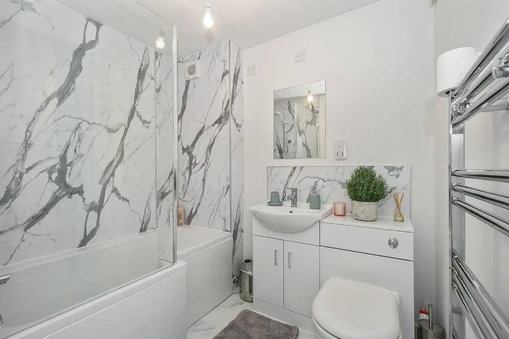 a white bathroom with a sink and a toilet and a tub at Modern seaside apartment ,Lossiemouth, Moray in Lossiemouth