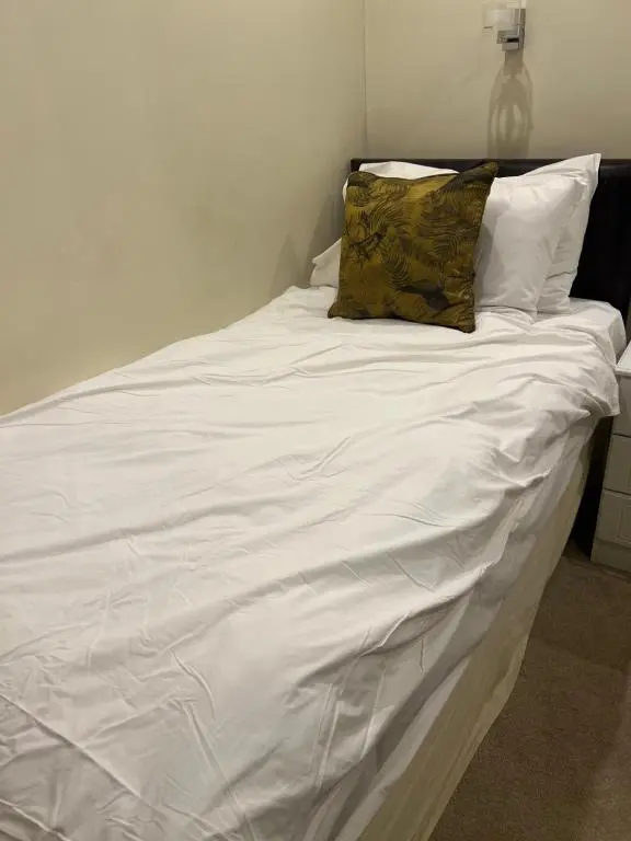 a large white bed with two pillows on it at The Aberlour Hotel in Aberlour