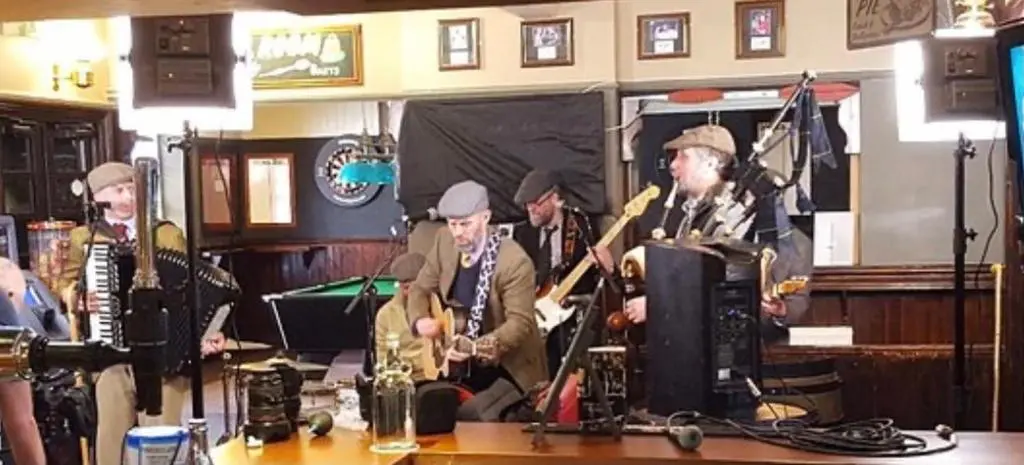 a group of men in a room playing music at Inverness city apartments - Innes in Inverness