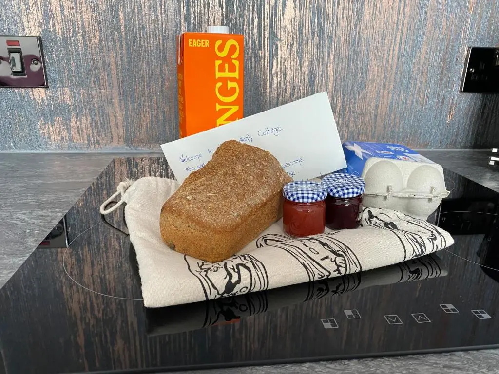 a plate with a loaf of bread on a table at Butterfly Cottage in Grantown on Spey