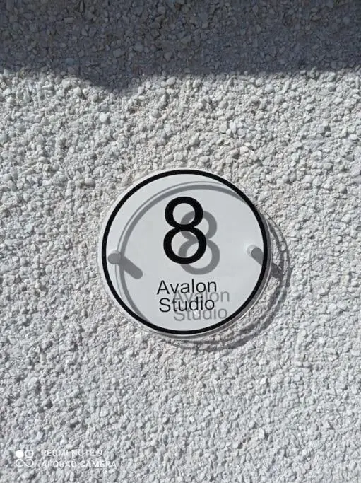 a metal button on a white carpeted floor at Avalon Studio. Comfy well equipped cosy studio. in Aviemore