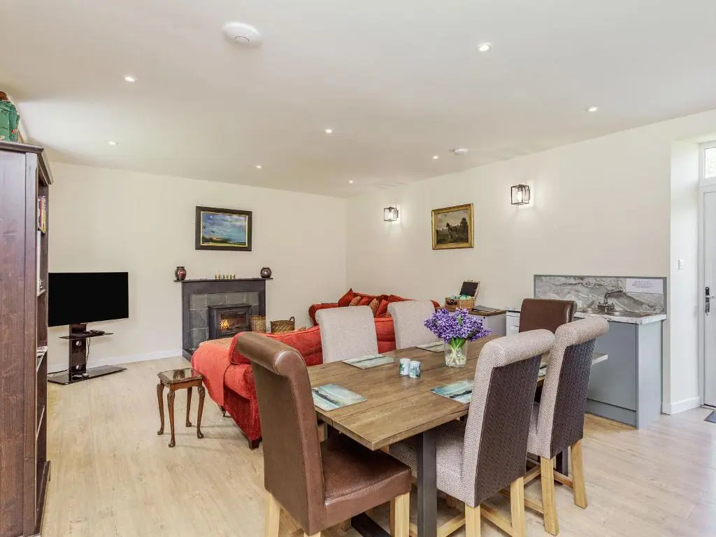 a living room with a table and a couch at New Cottage in Farr