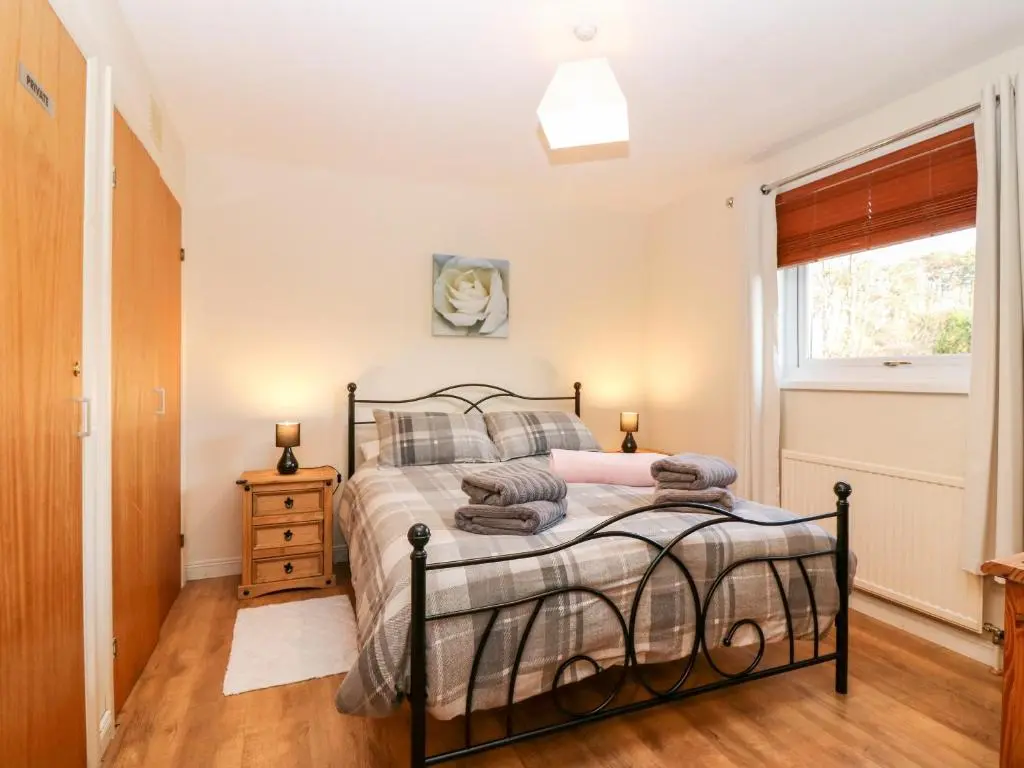 a bedroom with a bed and a window at 10 Annesley Park in Banchory