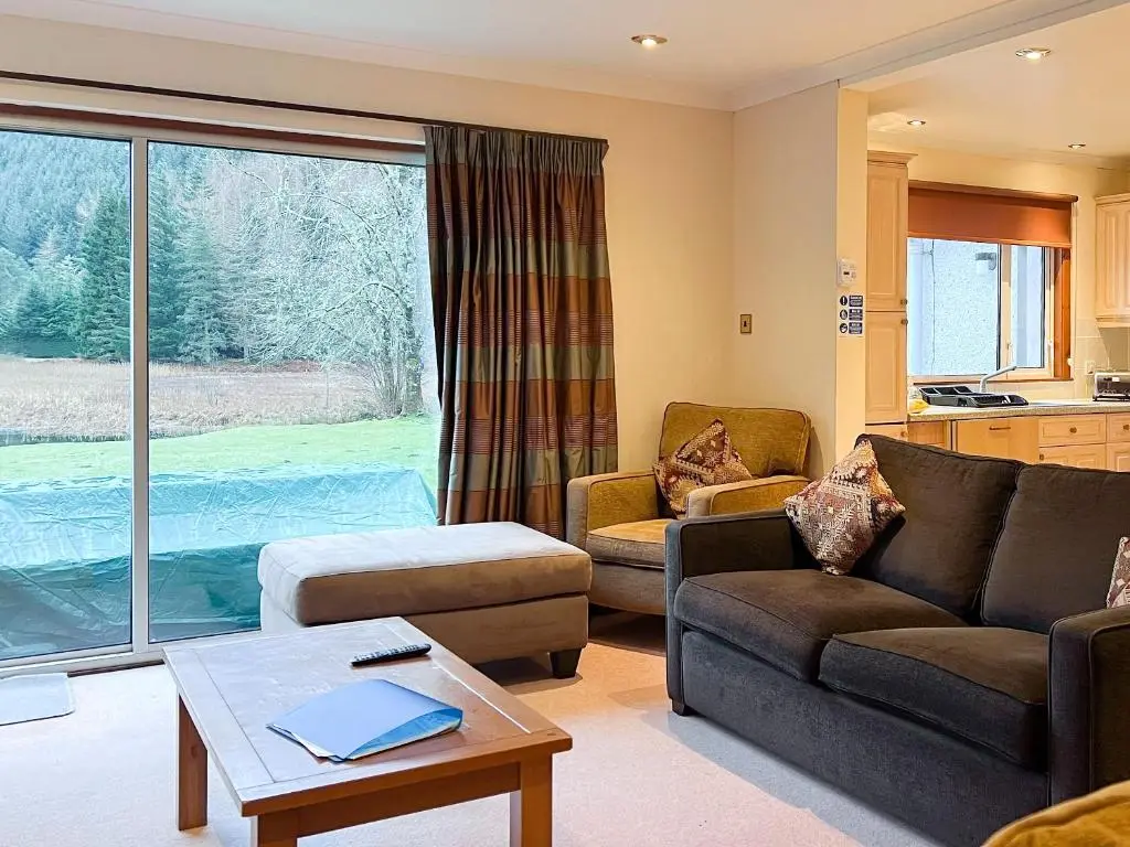 a living room with a couch and a table at Oich View - Uk37554 in Kilfinnan