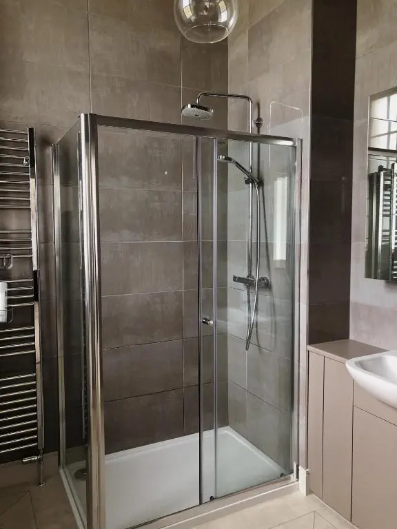 a shower with a glass door in a bathroom at 38 Great Glen Townhouse Inverness in Inverness