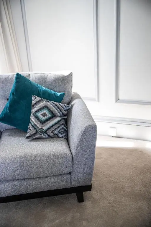 a couch with two pillows on it in a living room at Whitecraigs in Elgin