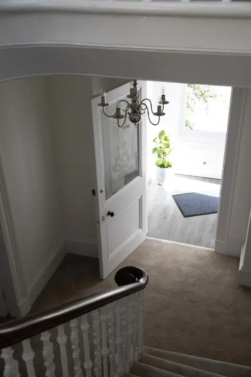 a hallway with a door leading to a stairway at Whitecraigs in Elgin
