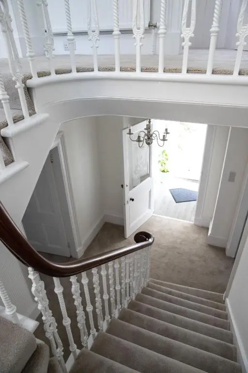 a staircase in a house with a white stair case at Whitecraigs in Elgin