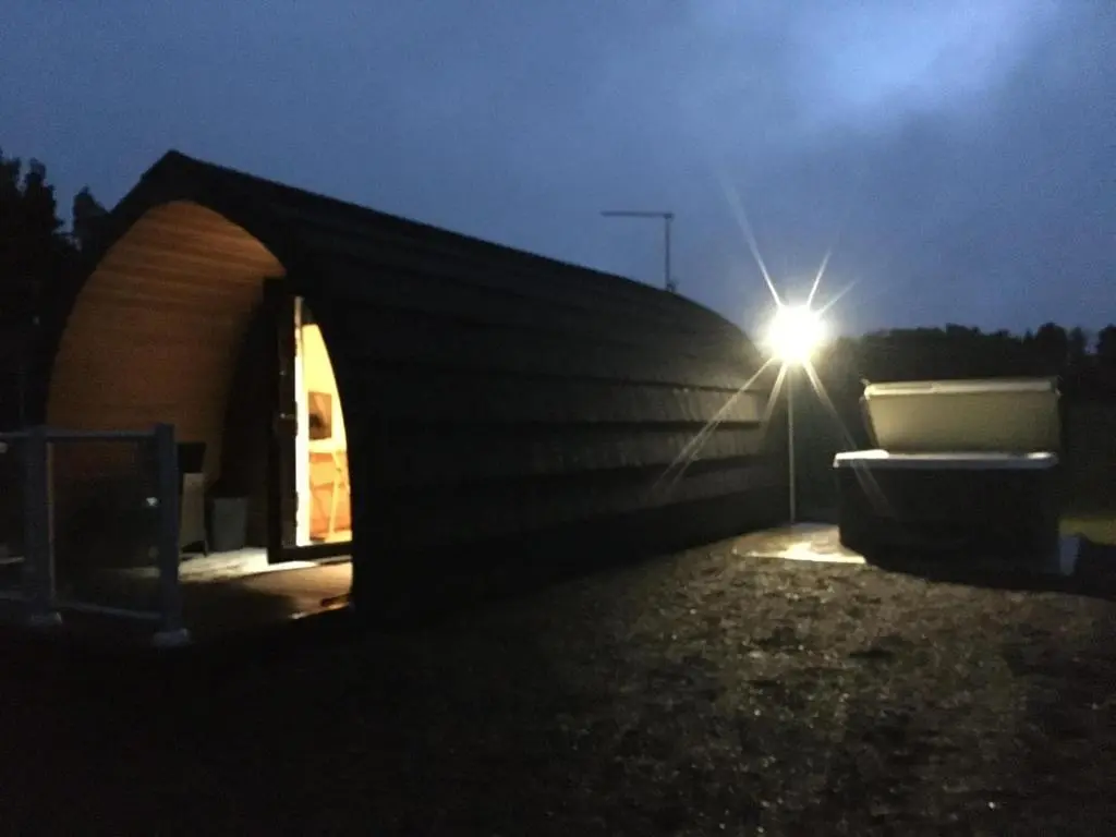a tent with a light on the side of it at Robins Nest Glamping Pod with Hot Tub in Keith