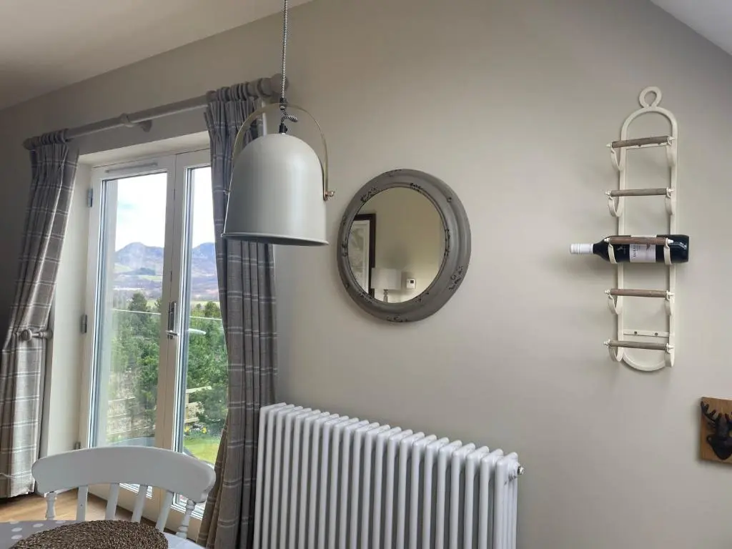 a room with a mirror and a radiator and a window at Little Thistle Apartment in Whitebridge