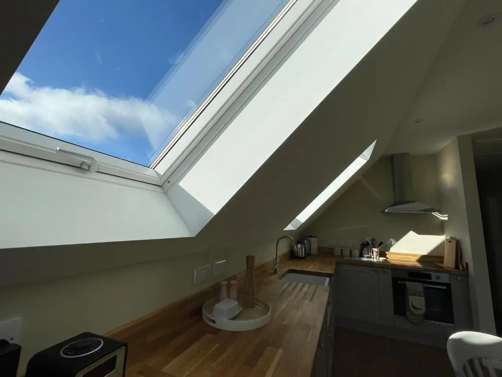 a kitchen with a large skylight in a loft at Little Thistle Apartment in Whitebridge