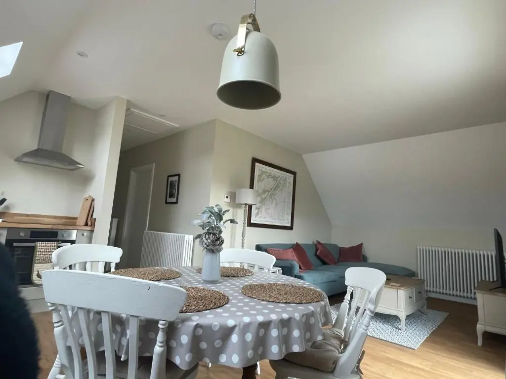 a living room with a table and chairs and a couch at Little Thistle Apartment in Whitebridge