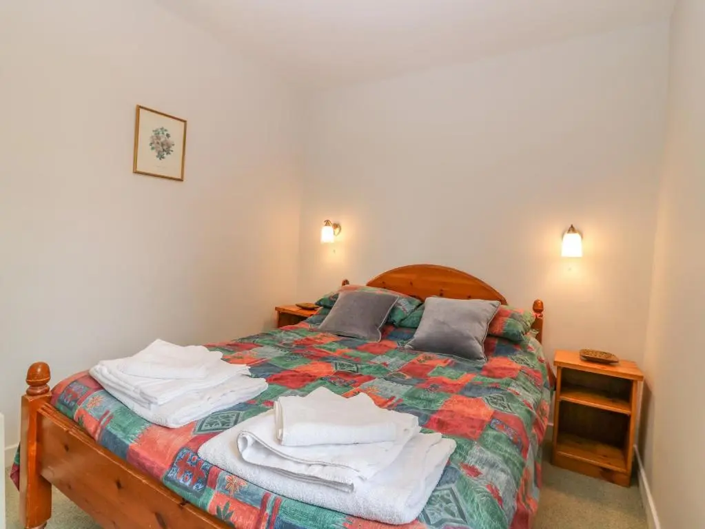 a bedroom with a bed with towels on it at The Bungalow in Elgin