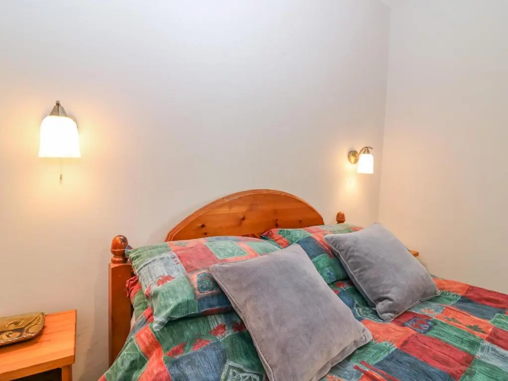 a bedroom with a bed with two pillows on it at The Bungalow in Elgin