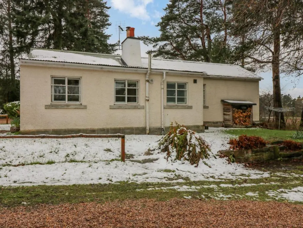 a white house with snow in front of it at The Bungalow in Elgin